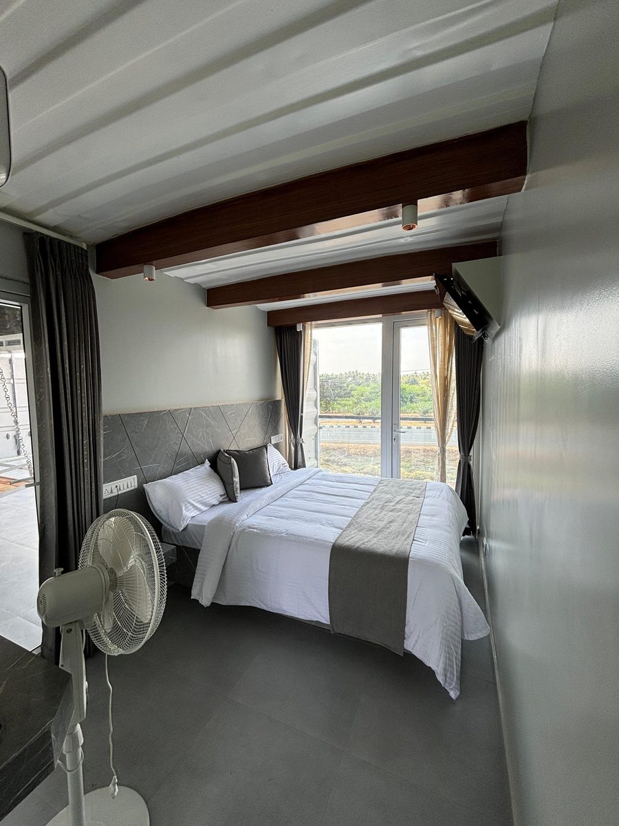Temple City Box Stays room overlooking green fields at Vadipatti